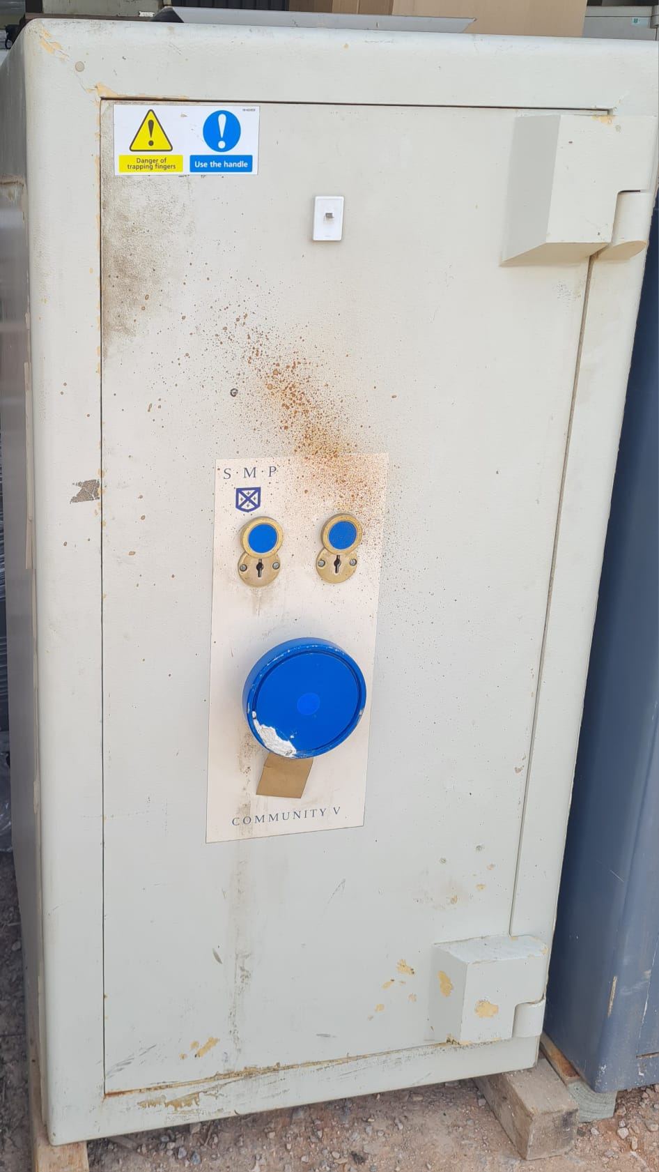 A commercial safe with twin key locks and a combination dial.