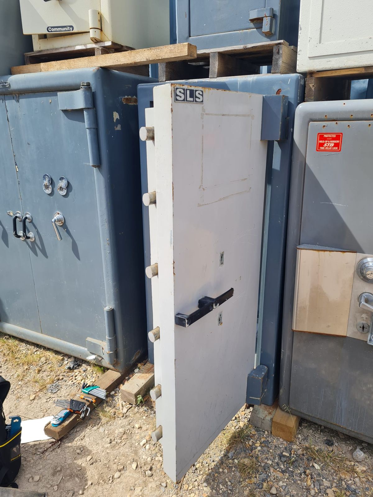 A safe door standing open with its locking bolts fully extended.