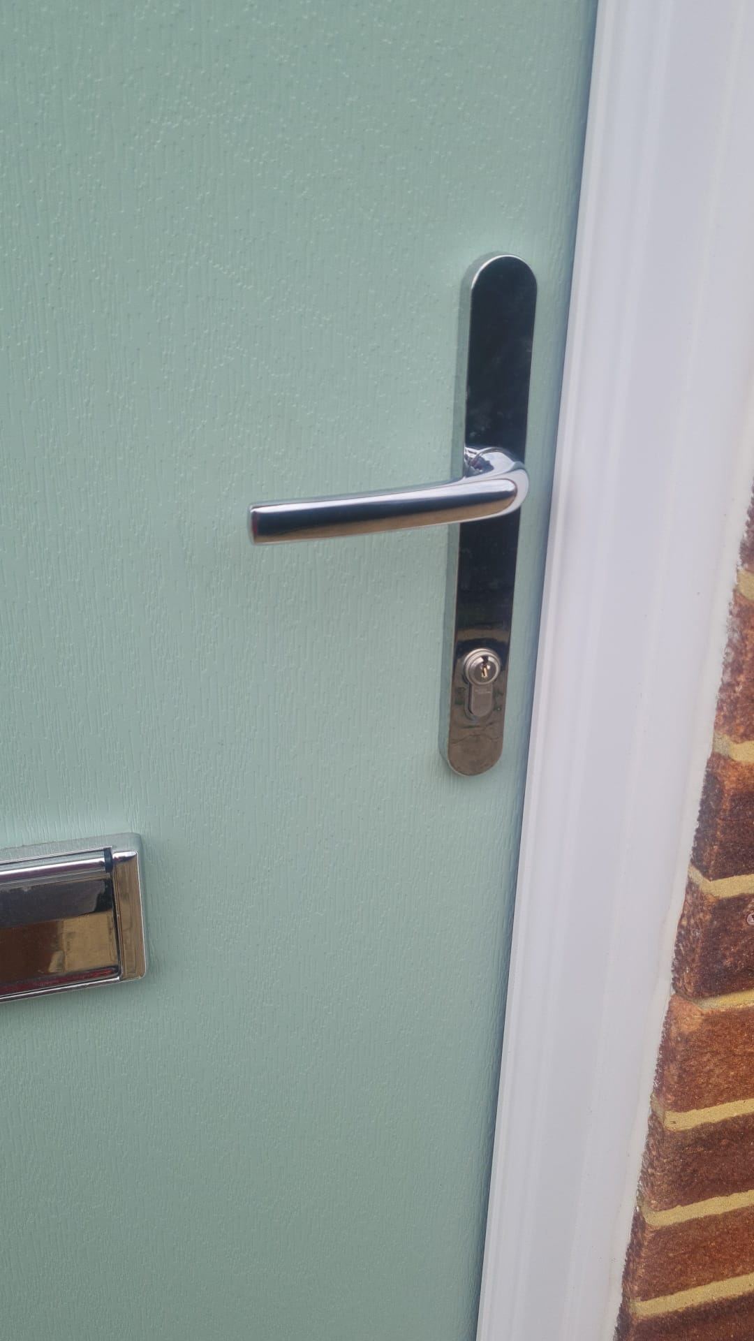 A new chrome handle and euro cylinder fitted to a composite front door.